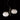 Oluce Alba 468 pendant light in satin brass with two blown glass spheres on a dark studio background