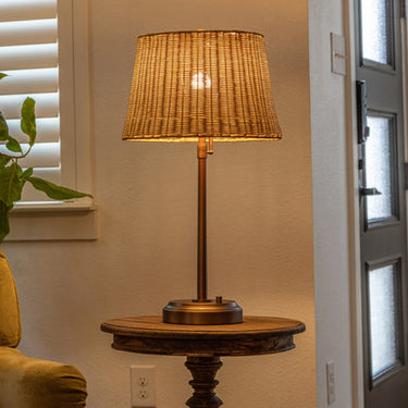 Alexis Cordless Table Lamp, a modern lantern with brass and rattan accents