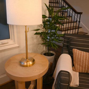 Alexis Cordless Table Lamp with brass base and linen shade on a side table
