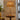Alexis Cordless Table Lamp's antique brass base and rattan shade