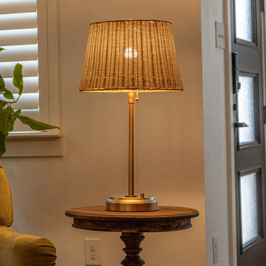 Alexis Cordless Table Lamp's antique brass base and rattan shade