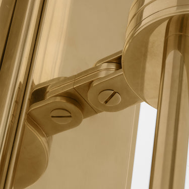 Luxury brass wall sconce with unique fluted glass design, damp rated for upscale restaurant restrooms or spa environments.