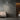 ET2 Alumilux Aster starburst of slim aluminum bars on a textured gray wall beside a cream leather sofa
