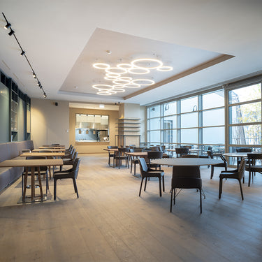Ripple Cluster white LED suspension light installed in hotel lobby setting