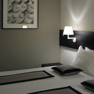 Artemide Melampo Mini Wall Light in grey finish mounted beside bed