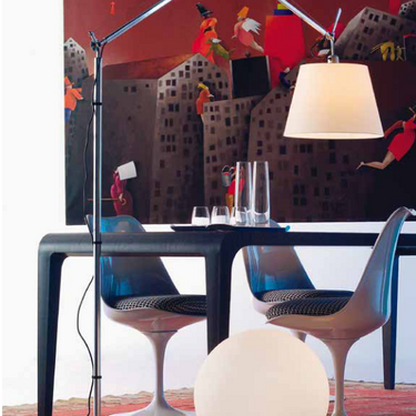 Tolomeo Mega LED adjustable floor lamp beside a modern dining room 