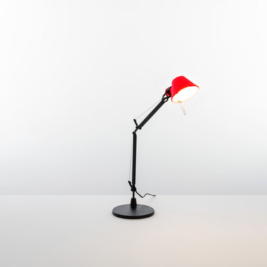 Adjustable Italian reading lamp Tolomeo Micro Red Shade with black frame for home offices, designed by Michele De Lucchi