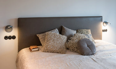 Minimalist Artemide Demetra LED wall light for residential bedrooms and commercial hallways