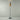 Aspen floor lamp in white over brass against a grey studio wall