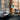 Teal Aspen floor lamp by a grey sofa and an egg chair in a brick loft