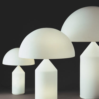 Atollo opal bedside lamp with geometric cone and dome silhouette in contemporary interior