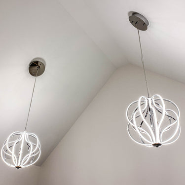 Two ET2 Aura pendants in Polished Chrome hanging under a vaulted white ceiling