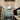 ET2 Aura pendant reflected in a vanity mirror beneath a vaulted ceiling