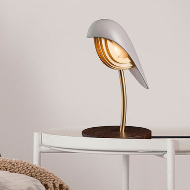 Almond Beige Bird lamp by Daqiconcept on a slim side table