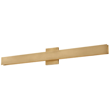 Natural Brass Bau 36" wall light illuminating a contemporary bathroom vanity.
