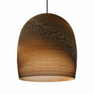Warm and inviting light emitted from a Graypants cardboard Bell pendant.