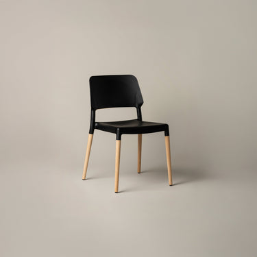 Modern black Belloch stackable chair with natural beech wood base designed by Lagranja Studio for Santa & Cole