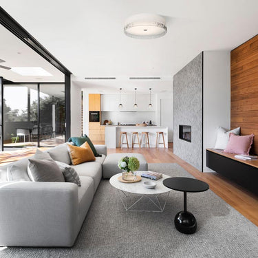 Contemporary glass ceiling light with soft ambient illumination installed in modern living room