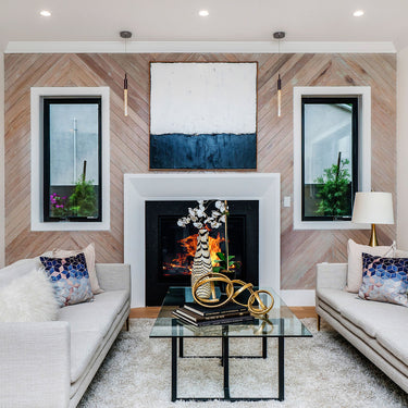 ET2 Big Fizz slim bubble glass pendants hanging either side of a fireplace wall in a living room with white sofas