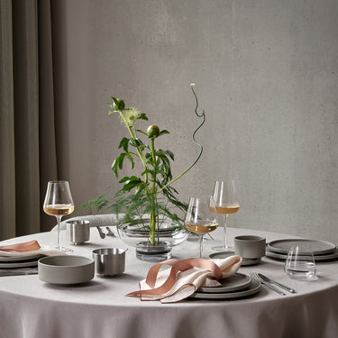 Clear BELO glasses on a round table with flowers | BELO by Frederike Martens for blomus