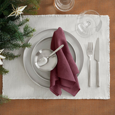 Clear red wine glass beside a holiday place setting | BELO by Frederike Martens for blomus