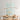 ET2 Blossom long branch pendant over a wood dining table with a pale blue artwork behind