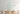 ET2 Blossom long branch pendant over a wood dining table with a pale blue artwork behind