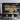 ET2 Blossom long branch pendant over a wood dining table in a dark kitchen with wood cabinets