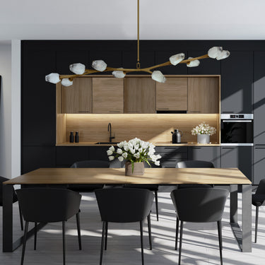 ET2 Blossom long branch pendant over a wood dining table in a dark kitchen with wood cabinets