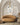 ET2 Blossom branch pendant hanging in an arched alcove above a round tan sofa