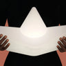 Goodnight Light The Boat Lamp floating in a swimming pool at night with a star-shaped reflection.