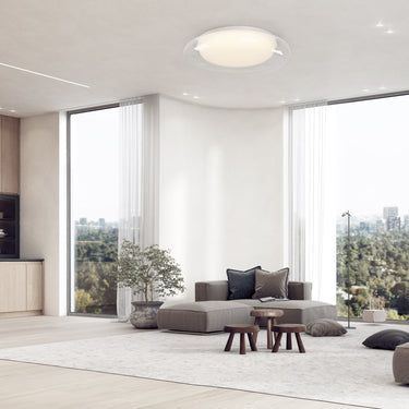 ET2 Bubble flush mount on the ceiling of a bright open living room with floor-to-ceiling windows and low gray sofas