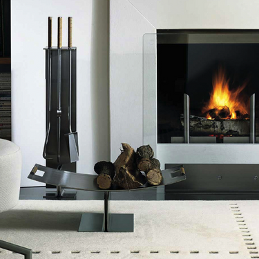 Conmoto Peter Maly Fireside Tools with Floor Stand, beside a fireplace with a log holder