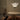 Shard pendant with honed alabaster petal-shaped panels above a round stone table