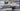 Gloved hands assembling a bronze fixture arm at a CTO Lighting workbench