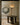 Shard pendant with honed alabaster panels in a doorway above a round dark marble table