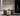 Modulo Horizontal pendant light in bronze hanging above a dining table