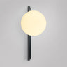 Tall Gaia wall light in bronze with a lit matt opal glass globe, shade facing up