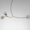 Ivy 3 pendant in bronze with satin brass details and 3 smoked glass globes, studio view