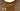Close-up of the textured smoked glass plate behind a lit opal dome on the Modulo wall light