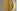 Close-up of a satin brass disc on the textured smoked glass of the Modulo Vertical pendant