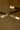 Close-up of glass shades at the ends of crossing bronze strands on the Trace Linear chandelier