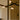 Close view of the Trace Linear chandelier strands crossing above a marble kitchen island