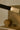 Close-up of a liquid cast glass shade at the end of a bronze strand on the Trace Linear chandelier