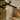 Crossing bronze strands with glass tips of the Trace Linear chandelier above a marble countertop