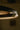 Close-up of the bronze edge and glowing alabaster of the Ceres pendant