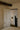 Ring wall light lit in a hallway beside a paneled door