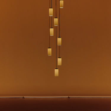 Modern cascading LED pendant fixture by Santa & Cole for staircases and tall ceilings