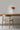 Ciro Wall light by Pablo Designs in Clay, mounted above a desk