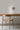 Ciro Wall light by Pablo Designs in Sand, mounted above a desk